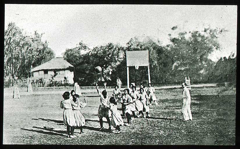 Girls playing basketball in the beginning of the twentieth century.